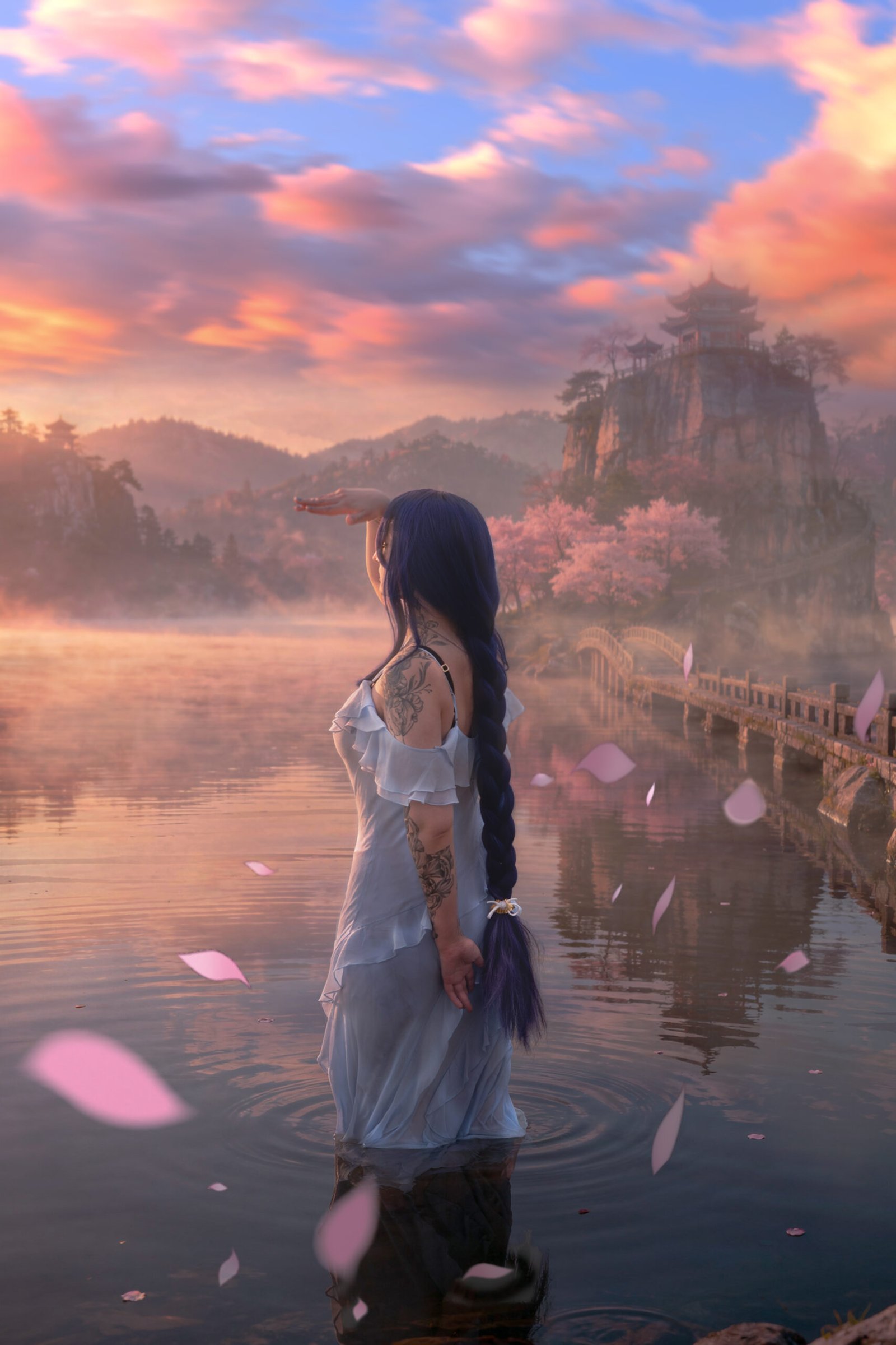 Hoyoverse creator Cosplayer in a light blue dress outfit standing in the middle of a lake in a sunset. Raiden Shogun cosplay